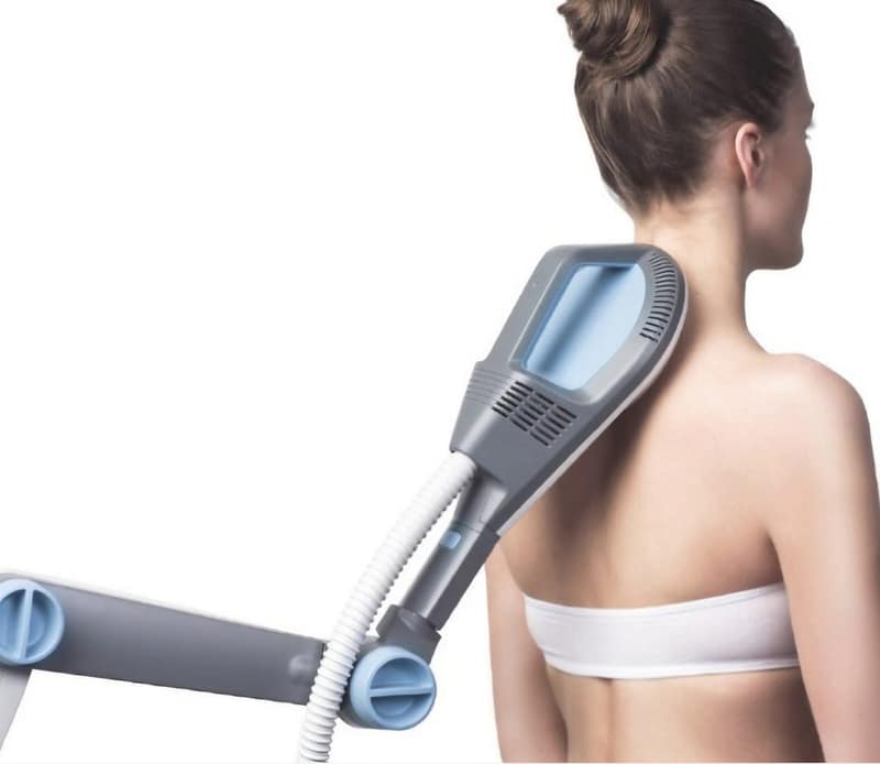 BTL Super Inductive System device applied to a patient's back, demonstrating non-invasive electromagnetic pulse therapy for muscle stimulation and pain relief.