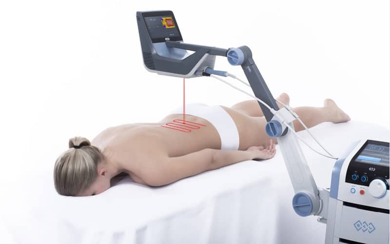 BTL Robotic Scanner Laser therapy system in use, targeting the back of a patient for non-invasive pain relief and healing.