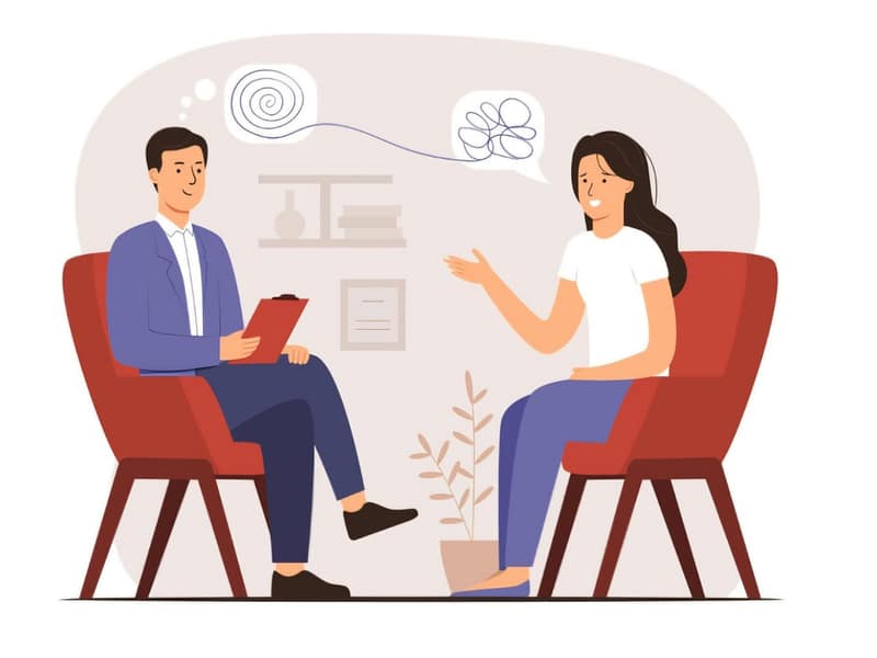 Counselling session illustration showing a male counsellor with a clipboard and a female client discussing emotions, symbolized by thought bubbles, in a comfortable setting.